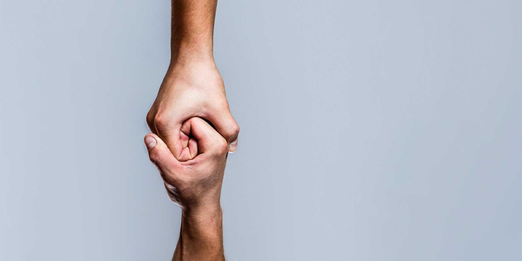 Photograph of two hands holding each other