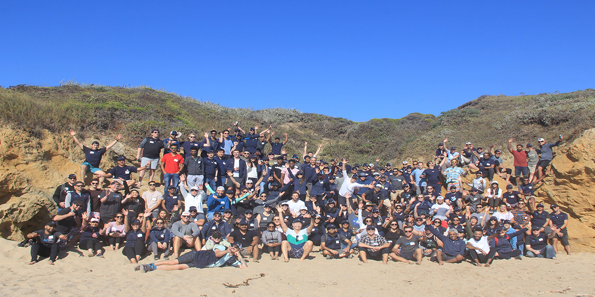 Photograph of the Clari team on a beach