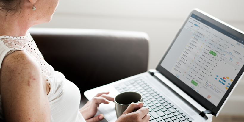 Photograph of a sales leader looking at a Clari report on a laptop