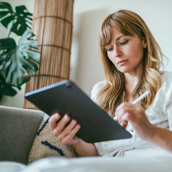 Photograph of a revenue leader writing on an iPad